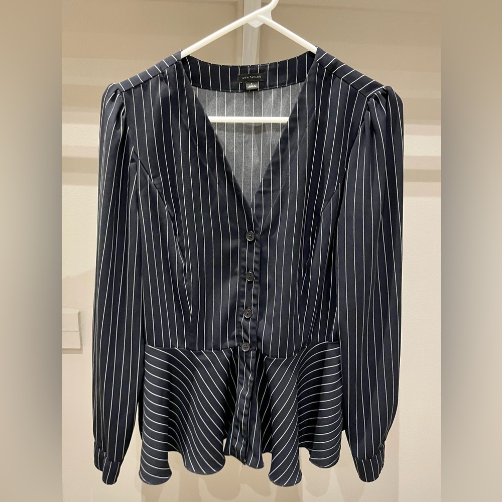 The perfect fall work shirt. Navy pinstripe with peplum to define your waist.